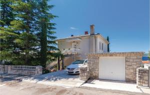 Gorgeous Apartment In Selce With Wifi في سيلتسي: سيارة متوقفة أمام منزل به كراج +20 صورة