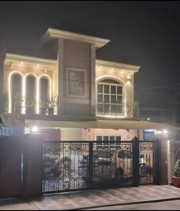 a house with a gate in front of it at night at Doctor's House in Lahore +11 photos