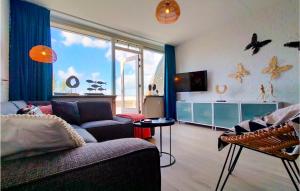 a living room with a couch and a large window at 2 Bedroom Stunning Home In Bruinisse in Bruinisse