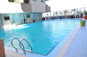 a large blue swimming pool in a building at Elilly International Hotel in Addis Ababa