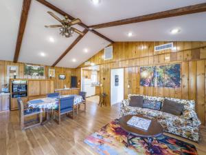a living room with a couch and a table at Yosemite Mountaintop Retreat on 100 acres, 2 Homes, 2 hot tubs, pool in Mariposa