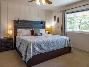 a bedroom with a large bed and a window at Yosemite Mountaintop Retreat on 100 acres, 2 Homes, 2 hot tubs, pool in Mariposa +59 photos