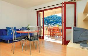 a living room with a table and chairs and a television at Apartment Brna Bb Iv in Brna