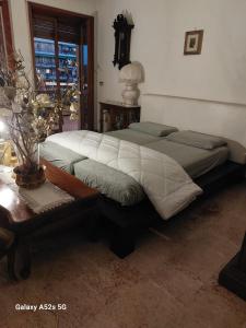 a bedroom with two beds and a table and a window at #Punto FM 6# in Marghera