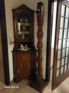 a large wooden cabinet in a corner of a room at #Punto FM 6# in Marghera