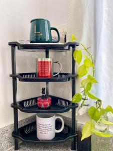 a black shelf with plates and cups on it at RANDA HOMESTAY at Grandville Subd Dalipuga Iligan in Iligan City