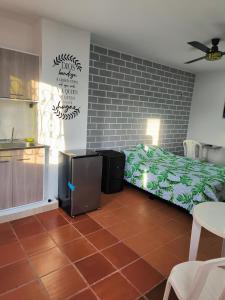 a bedroom with a bed and a brick wall at Apartaestudios la terraza 1 in Sincelejo