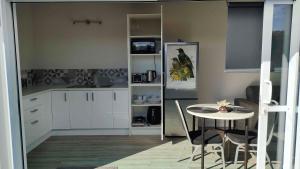 a kitchen with a table and chairs in a room at Container stay in Appleby