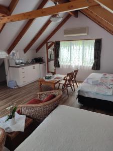 a living room with a bed and a table at Whitianga Luxurious studio room in Whitianga +3 photos