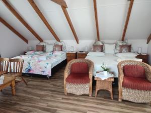a room with two beds and two chairs at Whitianga Luxurious studio room in Whitianga