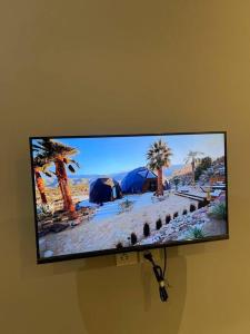 a flat screen tv hanging on a wall at Villa Oasis in Karachi