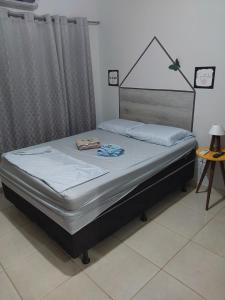 a bed sitting in a room with at Espaço Rafael kit net 6 in Maringá
