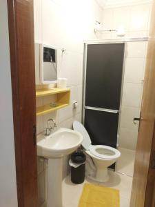 a small bathroom with a toilet and a sink at Espaço Rafael kit net 6 in Maringá +27 photos