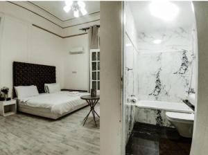 a bedroom with a bed and a tub and a sink at New Palace in Cairo +44 photos