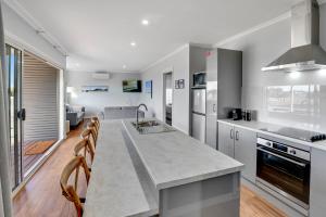 a kitchen with a large island in the middle at Kilsby Sinkhole & Accommodation in Mount Schank