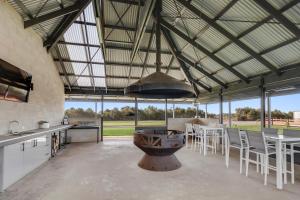a large kitchen and dining room with a large ceiling at Kilsby Sinkhole & Accommodation in Mount Schank