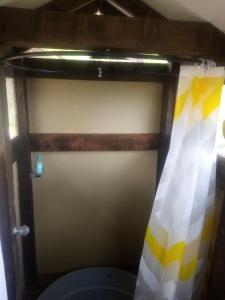 a bathroom with a toilet with a shower curtain at Cabañas M L el cocuy Boyacá in El Cocuy
