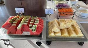 a display of different types of food on a table at The One Hotel in Bung Kan