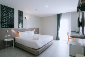 Postel nebo postele na pokoji v ubytování วัน บัดเจท เชียงราย บายพาสตะวันออก One Budget Hotel Chiangrai Bypass-East + 37 fotografií