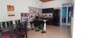 a kitchen with a table and chairs in a room at Casa Vacacional Flandes in Flandes
