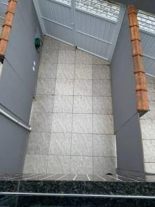 a view of a room with a tile floor at Aconchego Dutra in Praia Grande