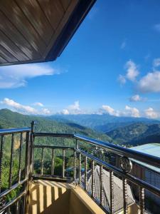 a balcony with a view of the mountains at Ina Puring's House in Itogon