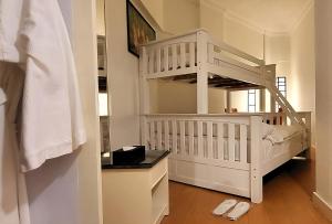 a baby room with a white crib and a staircase at Holiday Villa Resort & Beachclub Langkawi in Pantai Cenang