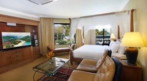 a hotel room with a bed and a television at Holiday Villa Resort & Beachclub Langkawi in Pantai Cenang