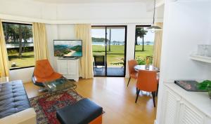 a living room with a couch and a table at Holiday Villa Resort & Beachclub Langkawi in Pantai Cenang