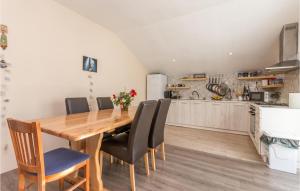 a kitchen and dining room with a wooden table and chairs at 3 Bedroom Amazing Apartment In Banjevci in Banjevci