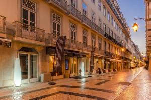 a street scene with people walking down the street at behotelisboa in Lisbon