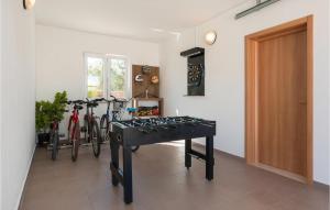 a ping pong table in a room with bikes at Holiday Home Loborika 45 in Loborika