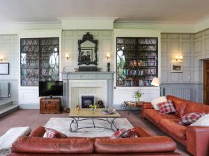 a living room with a couch and a fireplace at Stargazers - Uk3445 in Greenhaugh