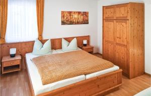 a bedroom with a wooden bed with two night stands at Holiday Home Hauptstrasse B in Eichigt +8 photos