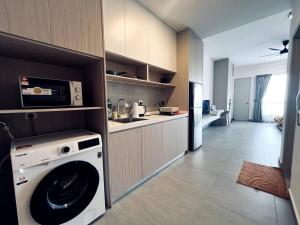 a kitchen with a washing machine in a room at Sunsuria Forum - Mika Homes in Shah Alam +12 photos