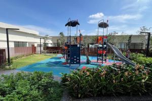 a playground with a slide in a yard at Sunsuria Forum - Mika Homes in Shah Alam