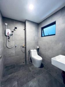 a bathroom with a shower and a toilet and a sink at Sunsuria Forum - Mika Homes in Shah Alam