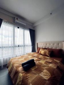 a bedroom with a large bed with a pillow on it at Sunsuria Forum - Mika Homes in Shah Alam
