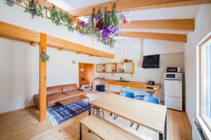 a living room with a table and a couch at FamB in Nakafurano +13 photos