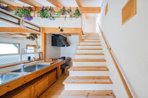 a staircase leading up to the kitchen in a tiny house at FamC in Nakafurano