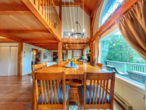 a dining room with a wooden table and chairs at Idyllic Retreat Swan Pond Views in Dennis