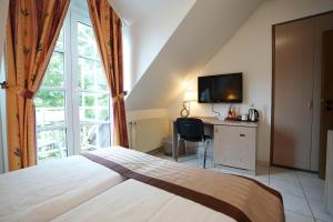 Postel nebo postele na pokoji v ubytování UNO Hotel Posthof Saarlouis