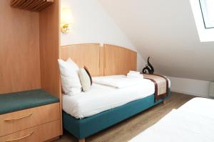 Postel nebo postele na pokoji v ubytování UNO Hotel Posthof Saarlouis