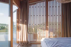 a bedroom with a bed and a large window at Szegzárd - the lodge in Szekszárd +95 photos