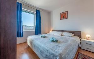 sypialnia z łóżkiem z niebieskimi ręcznikami w obiekcie 1 Bedroom Cozy Apartment In Pakostane w Pakoštane