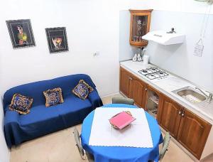 a kitchen with a couch and a table and a stove at Tranquil Three Cities Stay in Cospicua
