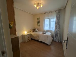 a small bedroom with a bed and a window at Aurrekoetxea 36 Vacation Rental Tala 10 in Bermeo