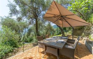 a table and chairs with an umbrella on a patio at 3 Bedroom Beautiful Home In Rapallo in Rapallo
