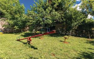 a playground in a yard next to a tree at 1 Bedroom Pet Friendly Home In Lovran in Lovran +20 photos