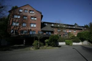 a large brick building with a street in front of it at Stargaze Home Hotel in Haan